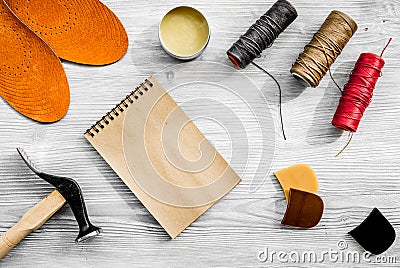 Cobbler takes order. Notebok on grey wooden desk background top view mockup Stock Photo