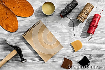 Cobbler takes order. Notebok on grey wooden desk background top view mockup Stock Photo