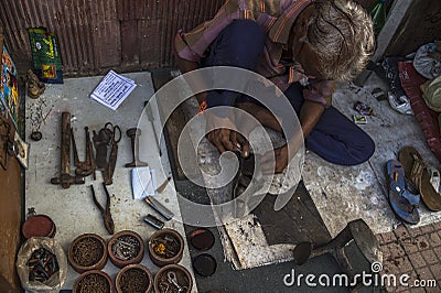 Cobbler Tools and at work Sayajigunj Vadodra Gujarat INDIA Editorial Stock Photo