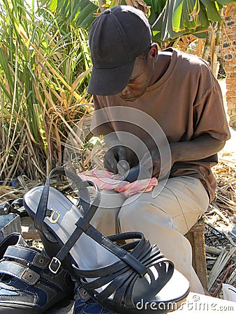 Cobbler working on roadside in Zimbabwe. Editorial Stock Photo