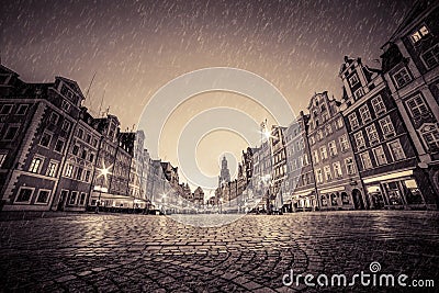 Cobblestone historic old town in rain at night. Wroclaw, Poland. Vintage Stock Photo