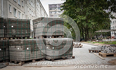 Cobblestones on pallets. Road repairs of apartment houses in the Stock Photo