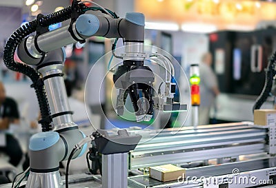 Cobot (Collaborative Robot) with electric gripper and sensor in automation line. Stock Photo