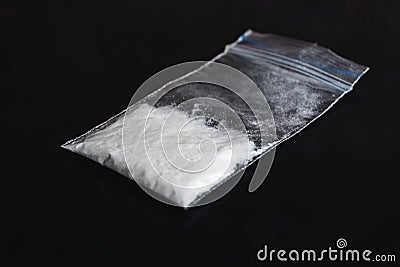 Cocaine in plastic packet on black background, closeup Stock Photo