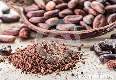 Cocao powder and cocao beans on the wood. Stock Photo