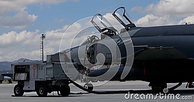 Cockpit of a modern grey NATO fighter jet plane parked at military air base Editorial Stock Photo