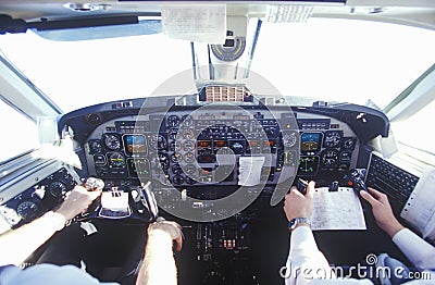 The cockpit and the pilots in a commuter airplane Editorial Stock Photo