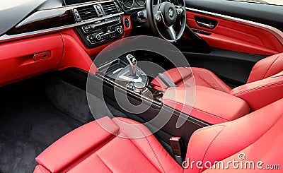 Cockpit view of an expensive German sports coupe showing the red leather interior. Editorial Stock Photo