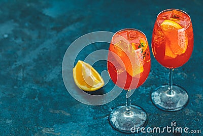 Cocktail aperol spritz in big wine glass with water drops on dark blue background. Summer Italian fresh alcohol cold drink. Stock Photo