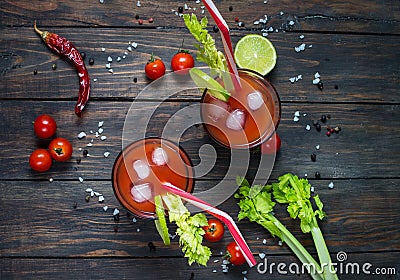 Cocktail Bloody Mary with ice in glasses on a wooden table Stock Photo