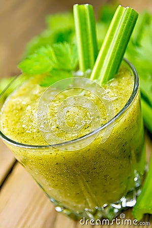 Cocktail with celery stalks in glassful on board Stock Photo