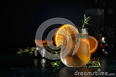 Cocktail gin tonic with ice, orange, and rosemary Stock Photo