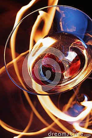 Cocktail glass over fire trace Stock Photo