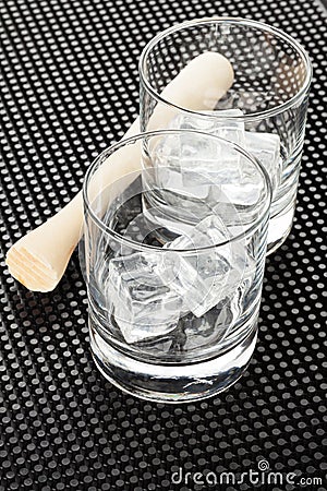 Cocktail glasses with ice and muddler Stock Photo
