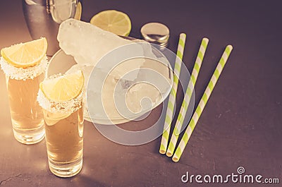 cocktail ingredients and Tequila shots/cocktail ingredients and Tequila shots on a dark background. Toned Stock Photo