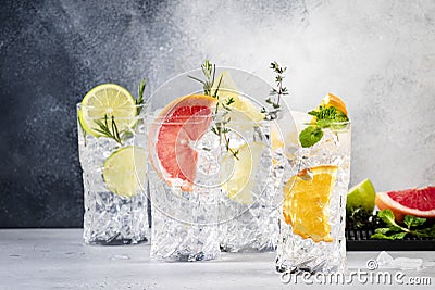 Cocktails set. Alcoholic drinks with gin, tonic, lime, lemon, grapefruit, orange, cucumber, soda and spicy herbs in wine glasses, Stock Photo