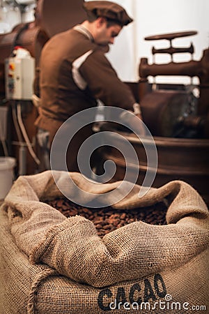 Cocoa beans and chocolatier in a chocolate making workshop Stock Photo