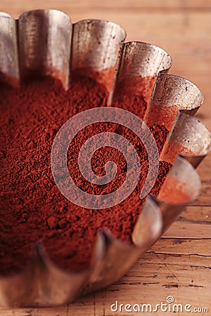 Cocoa beans in sieve with cocoa powder in tinware Stock Photo