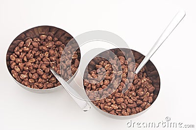 Cocoa coated puffed rice in metal bowls isolated Stock Photo