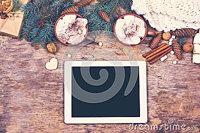 Cocoa, coffee, gift, fir branch, nuts, cones, cozy knitted blanket. Christmas cookies. Tablet PC. Winter, New Year, Christmas sti Stock Photo