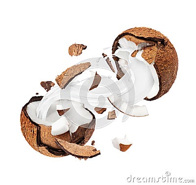 Coconut broken in the air into two halves with milk splashes, isolated on a white background Stock Photo