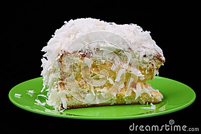 Coconut cake piece on green plate Stock Photo