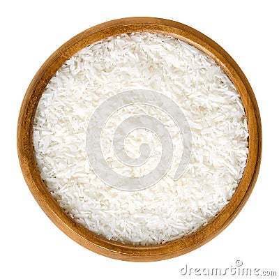 Coconut flakes in a wooden bowl over white Stock Photo