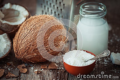 Coconut milk, grounded coconut flakes, coco nut and grater Stock Photo
