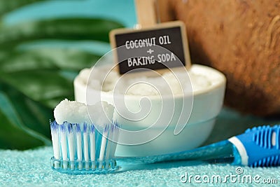 Coconut oil and baking soda in a bowl with a toothbrush - Homemade whitening toothpaste Stock Photo