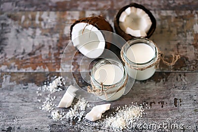 Coconut oil in a jar. Coconut halves. Stock Photo