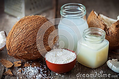 Coconut oil and milk, grounded coconut flakes and coco nut Stock Photo