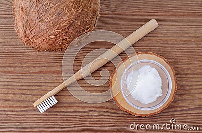 Coconut oil toothpaste, natural alternative for healthy teeth, wooden toothbrush, above Stock Photo