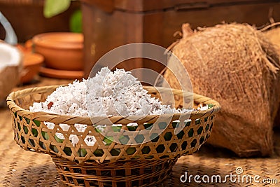 Coconut powder of a coconut in basket inside kitchen for making coconut milk Stock Photo