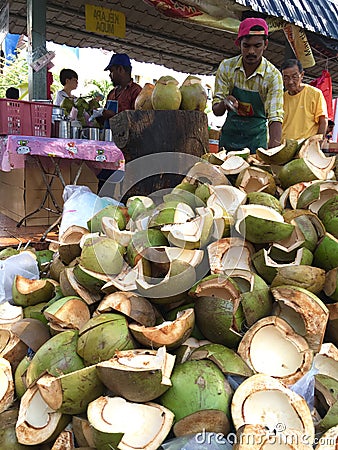 Coconut seller cutting coconut Editorial Stock Photo