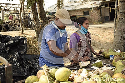 coconut seller preparing coconut to sell at frezargunj , westbengal, india Editorial Stock Photo