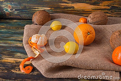 Coconut in shell with peeled tangerine. Stock Photo