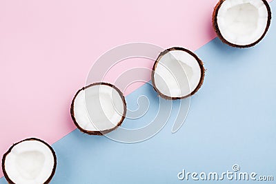 Coconut tropical fruit half on minimal pastel background top view. Creative summer pattern for modern design. Flat lay. Stock Photo