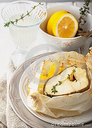 Cod fillets baked in parchment paper with slices Stock Photo