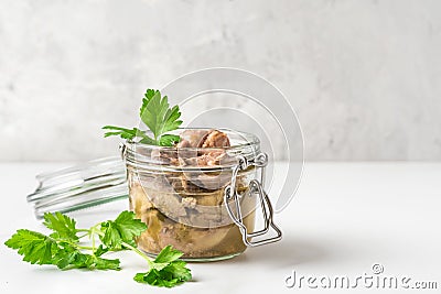 Cod liver in a jar with parsley. Natural source of omega 3 and vitamin D. close up Stock Photo