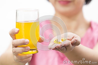 Cod liver oil and collagen dietary supplement in glass for drink Stock Photo