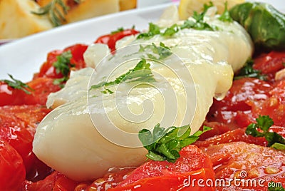 Cod loins with tomato on a plate Stock Photo