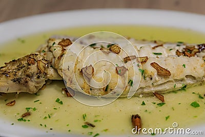 Cod with pil pil sauce traditional Basque dish in a restaurant in Pamplona Spain Stock Photo