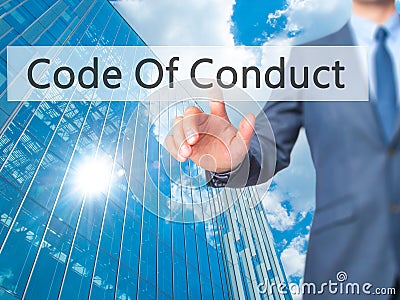 Code Of Conduct - Businessman hand pressing button on touch screen interface. Stock Photo
