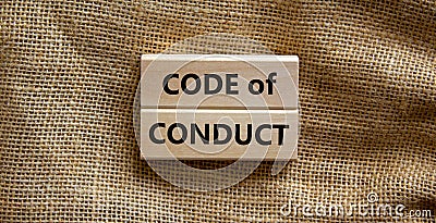 Code of conduct symbol. Concept words `Code of conduct` on wooden blocks on a beautiful canvas background. Business and code of Stock Photo