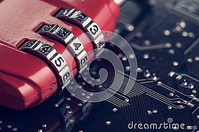 Code numbers on combination pad lock on computer circuit board w Stock Photo