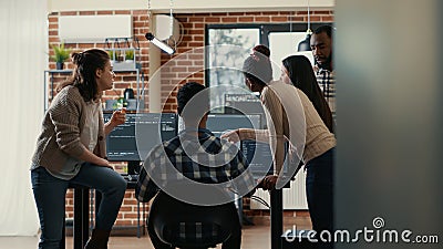 Coders discussing about source code compiling discovers errors and asks the rest of the team for explanations Stock Photo