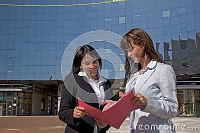 Coeds looking at a file Stock Photo