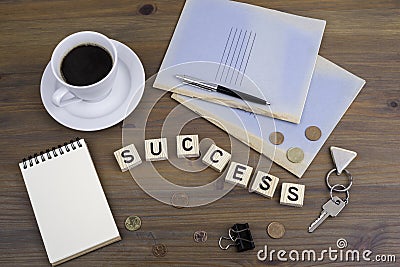 Coffe, pen, money and blocknot on a desk and word Success Stock Photo