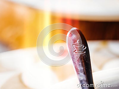 Coffe spoon with engraved steamed cup of tea or coffe Stock Photo