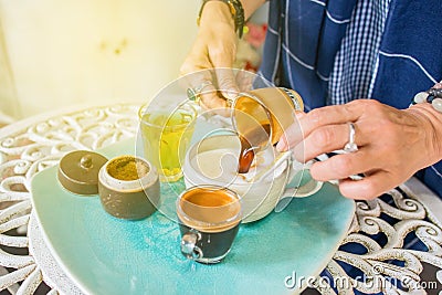 Coffee barista pouring black coffee mixing with fresh milk for breakfast menu at the coffee shop Stock Photo